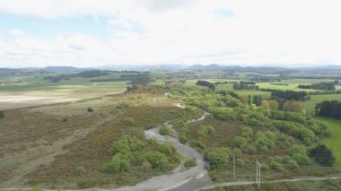 This drone photo captures the Selwyn River in New Zealand's Selwyn District, showcasing its vibrant waters and lush surrounding. clipart