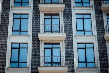 Close up of modern architecture building with big windows and balcony