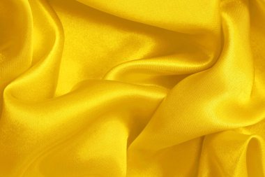 Yellow fabric cloth texture for background and design art work, beautiful crumpled pattern of silk or linen.