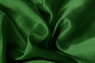 Arkaplan ve tasarım için koyu yeşil kumaş dokusu, güzel buruşmuş ipek ya da keten deseni..