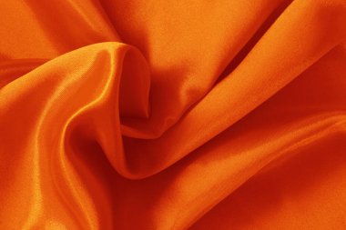 Arkaplan ve tasarım için turuncu kumaş dokusu, güzel buruşmuş ipek ya da keten deseni.