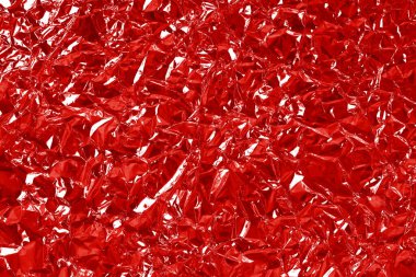 Kırmızı folyo yaprak parlak dokusu, arkaplan ve tasarım sanatı için soyut dalgalı kağıt.