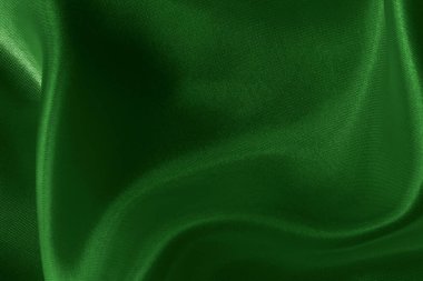 Arkaplan ve tasarım için koyu yeşil kumaş dokusu, güzel buruşmuş ipek ya da keten deseni..