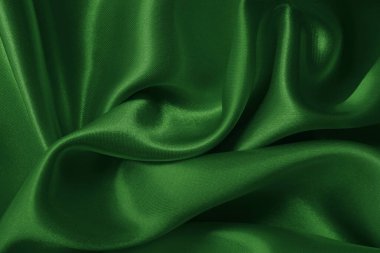 Arkaplan ve tasarım için koyu yeşil kumaş dokusu, güzel buruşmuş ipek ya da keten deseni..