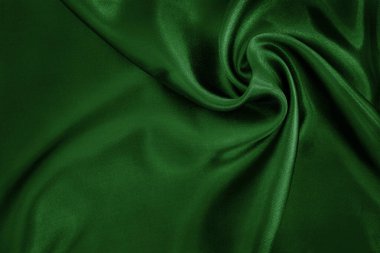 Arkaplan ve tasarım için koyu yeşil kumaş dokusu, güzel buruşmuş ipek ya da keten deseni..