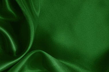 Arkaplan ve tasarım için koyu yeşil kumaş dokusu, güzel buruşmuş ipek ya da keten deseni..