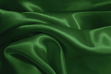 Arkaplan ve tasarım için koyu yeşil kumaş dokusu, güzel buruşmuş ipek ya da keten deseni..