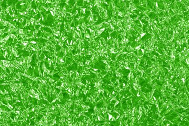 Yeşil kireç folyo parlak doku, arkaplan ve tasarım çalışmaları için soyut ambalaj kağıdı.