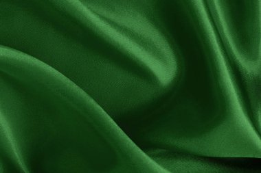 Arkaplan ve tasarım için koyu yeşil kumaş dokusu, güzel buruşmuş ipek ya da keten deseni..