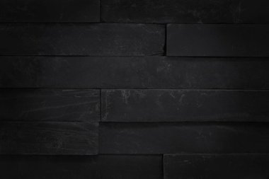 Arka plan ve tasarım çalışmaları için yüksek çözünürlüklü doğal desenli koyu gri kayrak dokusu. Siyah tuğla duvar.