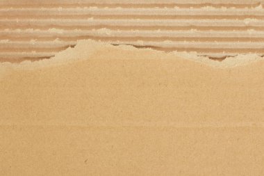 Kahverengi karton yaprak soyut arkaplan, geri dönüşüm kutusunun dokusu yırtık kenarlı eski model..