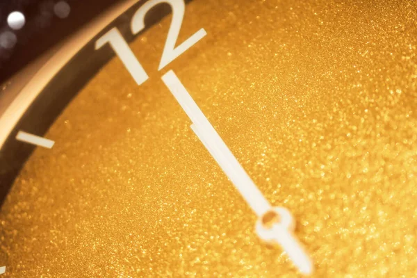 Gold clock, time telling on midnight and bokeh lights. Happy new year