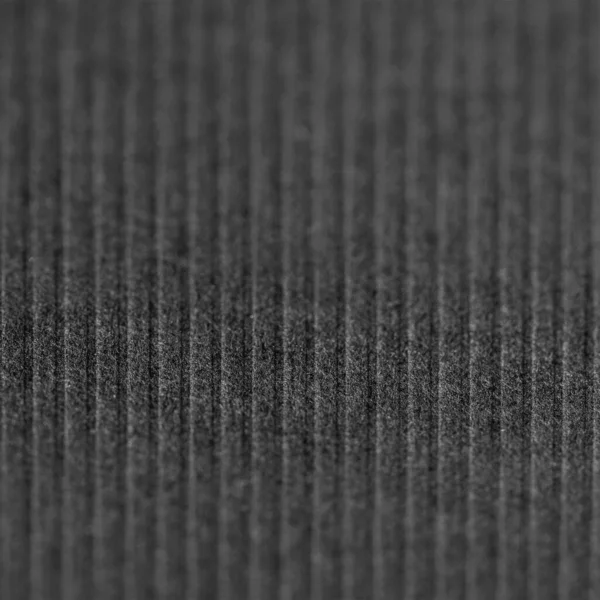 Fabric background with vertical lines with focus line. Modern look, selective focus. Black geometric lines background. Modern dark abstract texture.