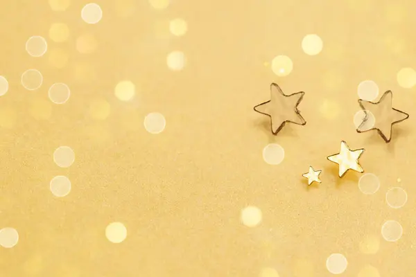 Gold Star on Glowing Blurred Background. Star Abstract Decoration Lights, Gold Sparkles and Blurred Shine Background for Holiday Greeting Concept.