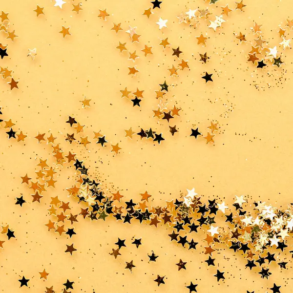 Glittering Christmas Stars on Gold Background. Festive concept