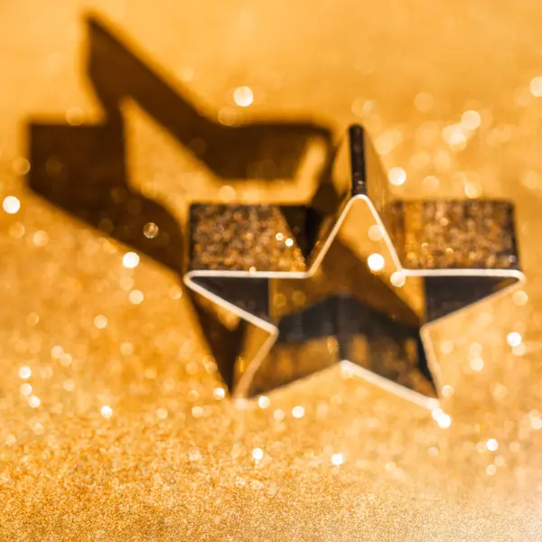 Star on Sparkling Gold Defocused Bokeh Background. Christmas Ornament. Glitter Defocused Gold Lights.