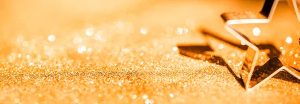 Sparkling Gold Defocused Bokeh Background with Star. Christmas Gold Lights.
