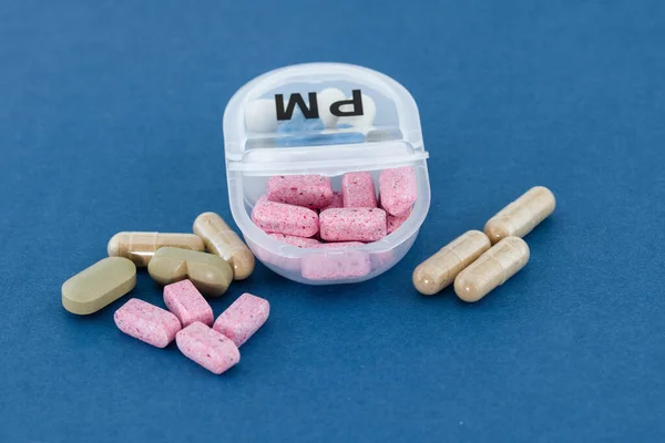Daily pill box, drug dose, pills organized in a pill box