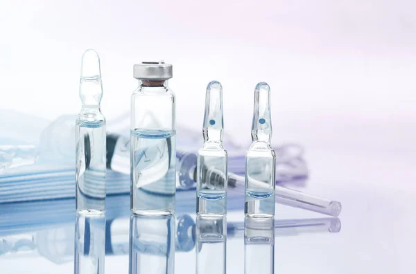 Vaccination or drug concept image, ampoules with Covid-19 vaccine on a laboratory bench.