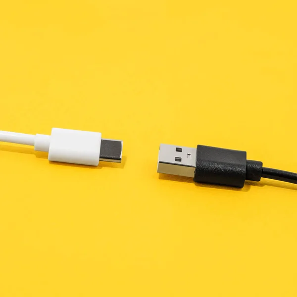 USB cable, type C cable over yellow background