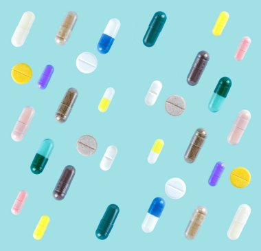 Seamless pattern of different colorful pills on soft blue background clipart