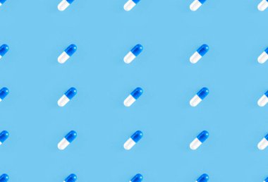 Two-piece pills on blue background. Medical pharmacy seamless pattern. clipart