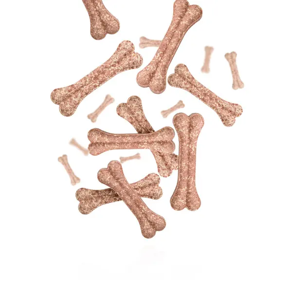 stock image Flying and falling protein bones for dog, rawhide bone, dog biscuit against a white background. Concept for healthy cooking.