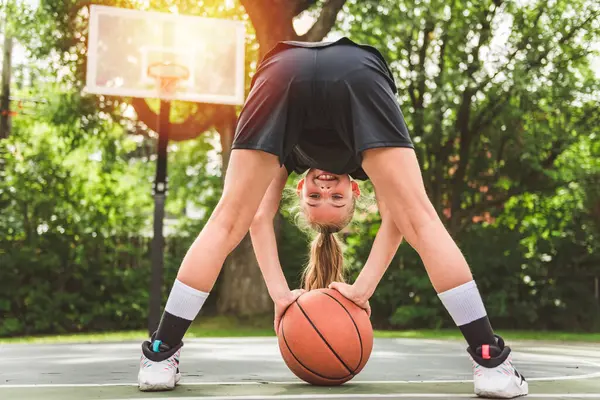 Stock image A girl with basketball on court on summer season