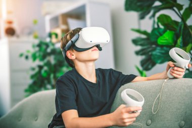 A Little boy with VR glasses on living room clipart