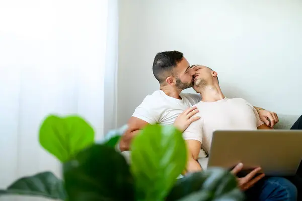 stock image A Happy young two man couple using laptop computer while sitting on a couch at home