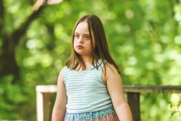 stock image A portrait of trisomy 21 child girl outside having fun on a park