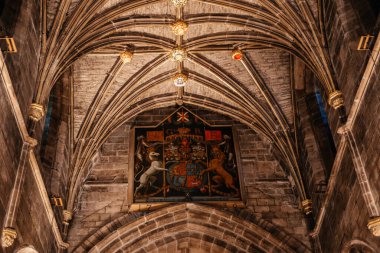 The intricate vaulted ceiling and royal coat of arms inside St Giles Cathedral in Edinburgh, showcasing detailed gothic architecture clipart