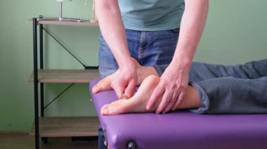 Plantar fasiiti tedavi etmek için ayaktaki IASTM tedavisini uygulayan terapist plantar fasyasını serbest bırakıp gererek ve ağrıyı azaltarak