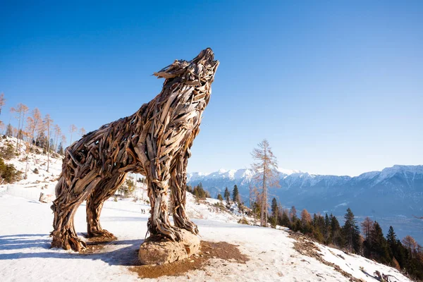 stock image Wooden sculpture of a wolf made of tree branches. Vaia tempest wolf