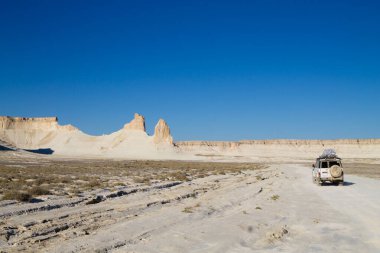 Bozzhira Vadisi 'nde off-road aracı, macera yolculuğu, Kazakistan. Kaya zirveleri oluşumları
