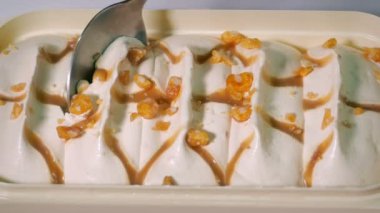 Scooping Caramel Ice Cream With Spoon