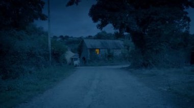 Fly Up To Building With Light On In The Evening