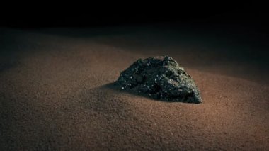Metal Ore In The Sand Circling Shot