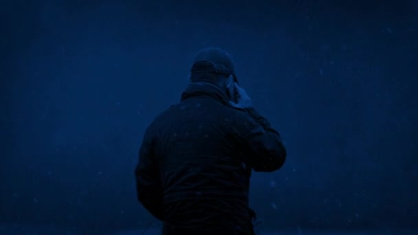 Snowing Man Talking Phone Night — Stock Video