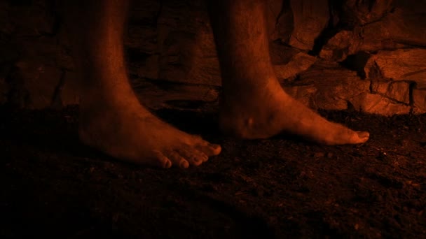 Barefoot Man Walks Cave Firelight — ストック動画