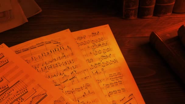 Hand Written Sheet Music Fire Glow — стоковое видео