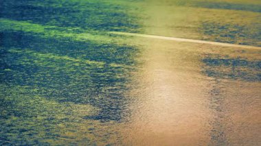 Islak Yoldaki Arabalar Şehrin Renkli Işıklarını Yansıtıyor