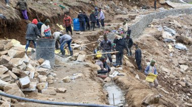 Rudarpray, Uttarakhand, Hindistan, 3 Mayıs 2014, Kedarnath faciasında hasar gören yolu yeniden inşa eden işçi. Kedarnath, Haziran 2013 'te heyelan ve ani sel felaketleri sonucu yıkıldı.