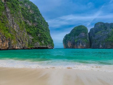 Maya bay beach with turquoise water and waves with no people in a paradise island Koh Phi Phi Le. Located in Andaman sea in Thailand