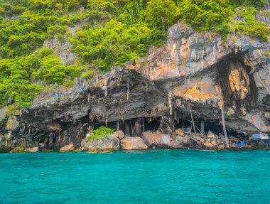 A wooden pier at the Viking cave where birds nests are collected, on the shore of Phi Phi islands in Andaman Sea, Thailand