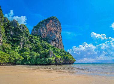 Railay west beach in Krabi district Thailand. Paradise beach with golden sand and green mountains around