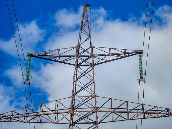 stock image High voltage line poles and wires with blue sky and white clouds background