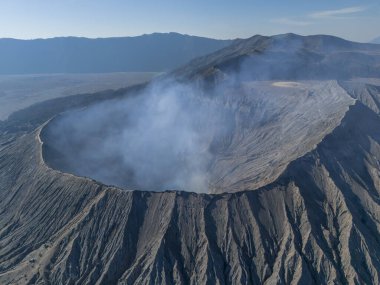 Bromo volkan kraterinin hava manzarası, duman geliyor. Doğu Java, Endonezya 'daki Tengger Semeru Ulusal Parkı' nda aktif bir volkan..