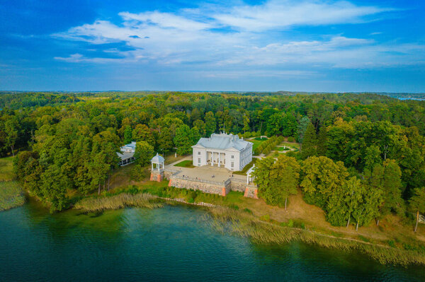 Aerial drone view shot of Uzutrakis Manor in Trakai Galve lake, Lithuania during daylight in autumn