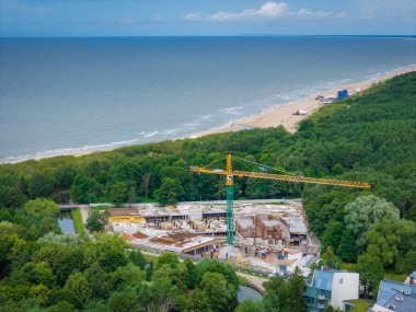 Deniz kenarında modern bir otel ve SPA kompleksi inşa ediliyor. Baltık Denizi kıyısındaki Palanga tatil köyü, Litvanya. Hava aracı görünümü